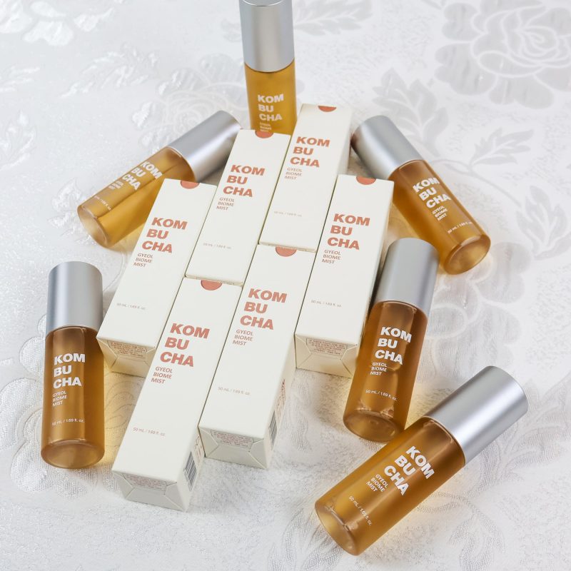 Amber Elishacoy Kombucha Gyeol-Biome Mist bottles arranged on a light textured surface