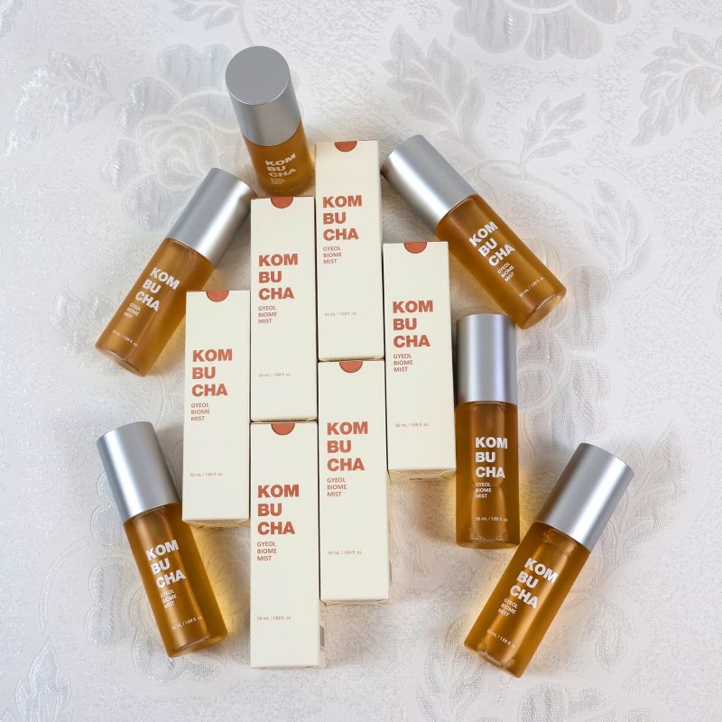 Elishacoy Kombucha Gyeol-Biome Mist bottles and packaging arranged for a beauty still life photography shoot